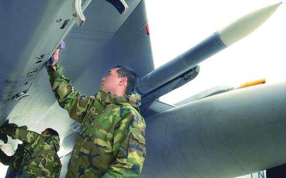 Mihail Kogalniceanu Air Base, Romania, May 2, 2007: Senior Airman Ignacio Flores, right, and Airman 1st Class Anthony Andrzejewski, left, both weapons troops assigned to the 493rd Aircraft Maintenance Unit, clean up an F-15 Eagle after a sortie over Eastern Romania in May.The unit is in Romania with some 200 airmen from the 48th Fighter Wing and members of the 100th Air Refueling Wing for two weeks training with their Romanian counterparts.

Read the story on the training exercise here: https://www.stripes.com/theaters/usafe-strengthens-partnership-with-romanians-1.64356

META TAGS: , Romania; U.S. Air Force; NATO; 