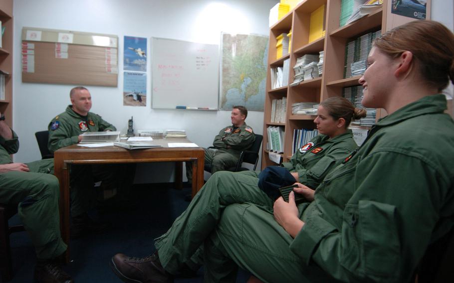 A sailor briefs service members