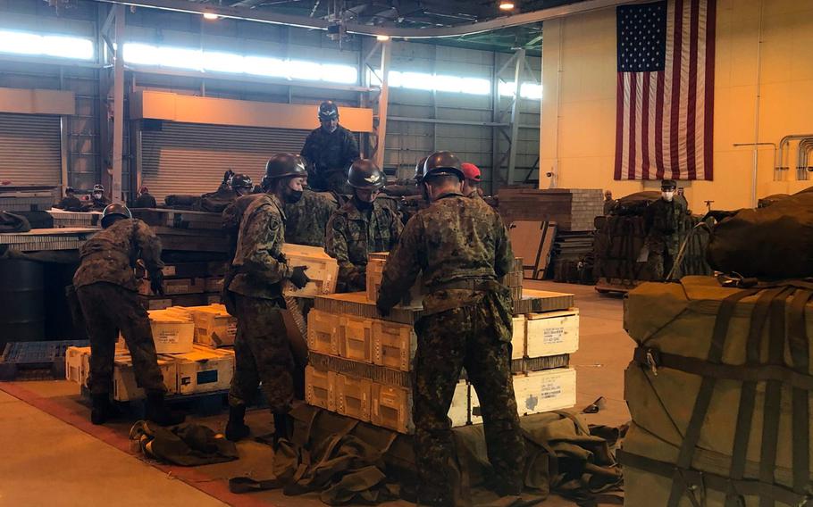 Members of the Japan Ground Self-Defense Force build airdrop bundles inside a logistics warehouse at Yokota Air Base, Japan, Jan. 25, 2023. 