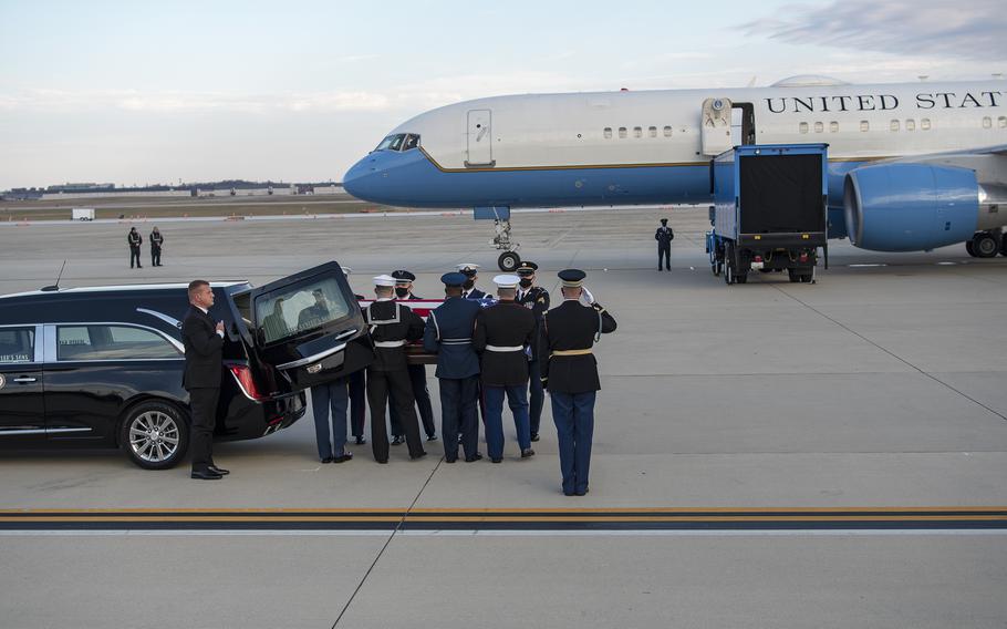 Members of a joint honor guard remove the casket of WWII veteran and former Kansas Sen. Bob Dole from a hearse at Joint Base Andrews, Md., on Friday, Dec. 10, 2021.