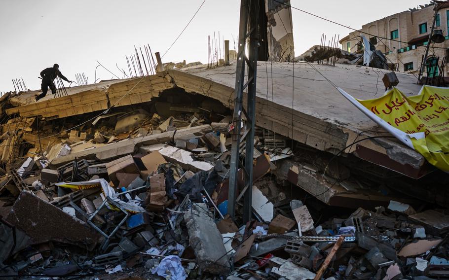 Police officers inspect the ruins of Samir Mansour's bookstore, as well as nearby buildings that were destroyed by Israeli bombardment during the last escalation, which lasted 11 days between Israel and Gaza military factions, in Gaza City on Saturday, May 29, 2021.