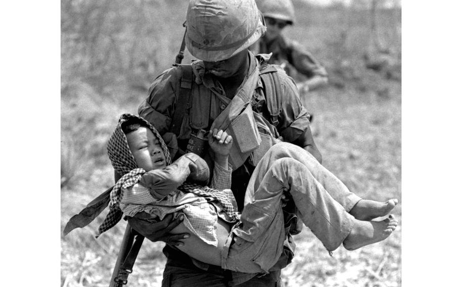 George Edmonds carries a wounded Vietnamese child