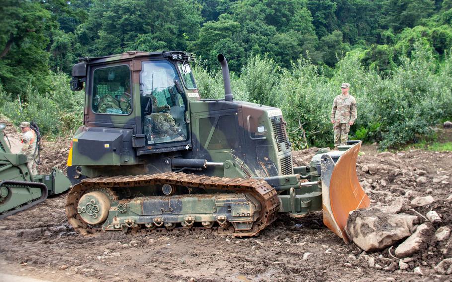 Soldiers of the 11th Engineer Battalion, 2nd Infantry Division clear debris from recent fatal flooding and landslides in Yecheon county, South Korea, July 27, 2023.
