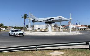 A car travels in a roundabout near one of the gates at Naval Station Rota, Spain, in August 2022. The base recently reintroduced a points system to penalize drivers for a range of traffic violations.