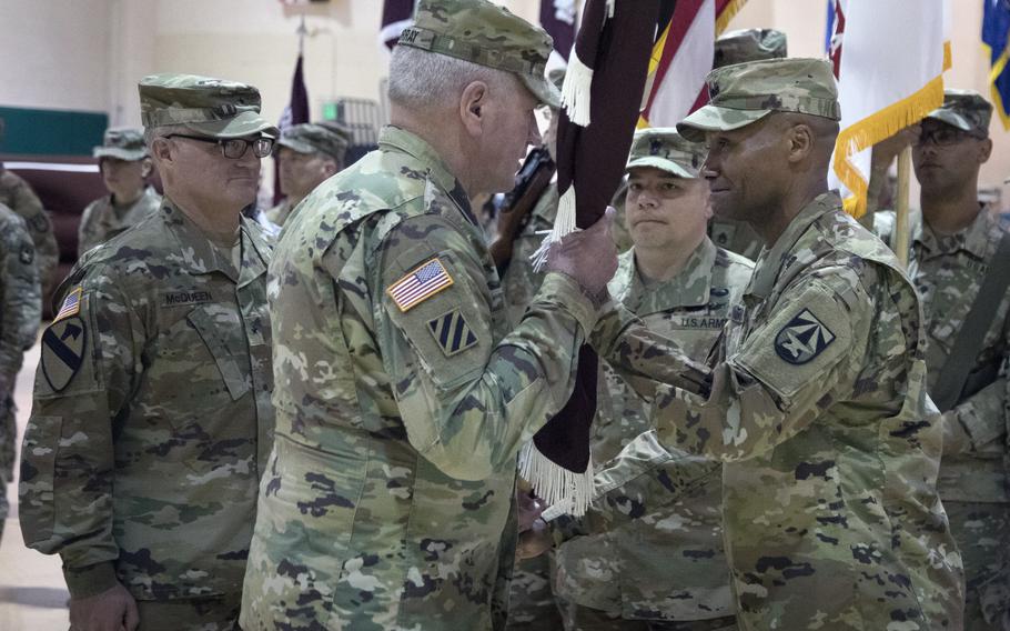 Maj. Gen. Michael Talley, far right, Commanding General of the U.S. Army Medical Research and Development Command (MRDC) and Fort Detrick, Maryland, hands the MRDC unit colors to Gen. John Murray, Commanding General U.S. Army Futures Command, during a Change of Command ceremony, June 22, 2021, at Fort Detrick. Talley relinquished command to Brig. Gen. Anthony McQueen.