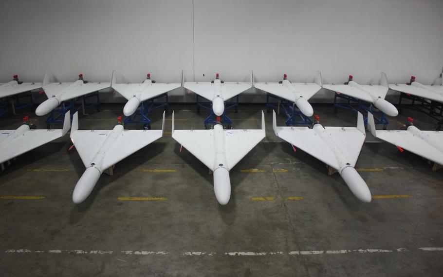 Two rows of white drones.