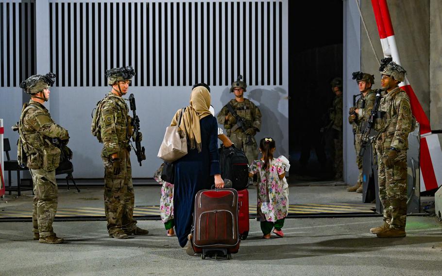 Army paratroopers guard a gate Aug. 22, 2021, in Kabul, Afghanistan, during the evacuation of U.S. citizens, Special Immigrant Visa applicants and other at-risk Afghans. New SIV applicants will no longer have to send a form to the Department of Homeland Security and will deal exclusively with the State Department, senior White House officials said July 18, 2022. 