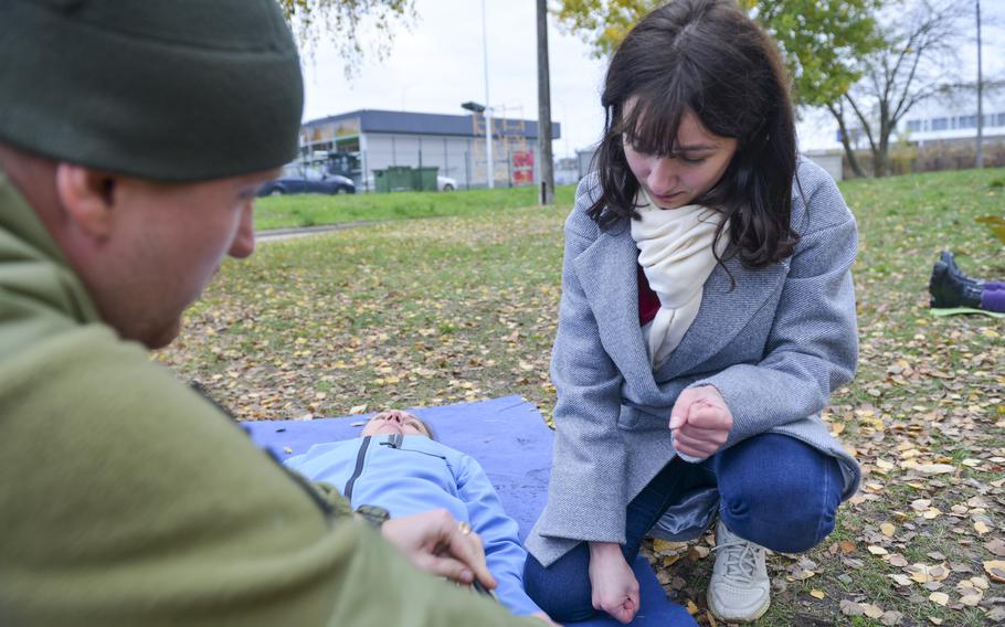 Masha, a Ukrainian woman who declined to give her last name, learns first aid at a training site outside Kyiv, on Oct. 27, 2022. Masha said she lived through chaos during the Russian invasion, which happened as she visited Mariupol, where her parents live. She said she wanted to know first aid so she’s better prepared for war in the event she experiences it again.