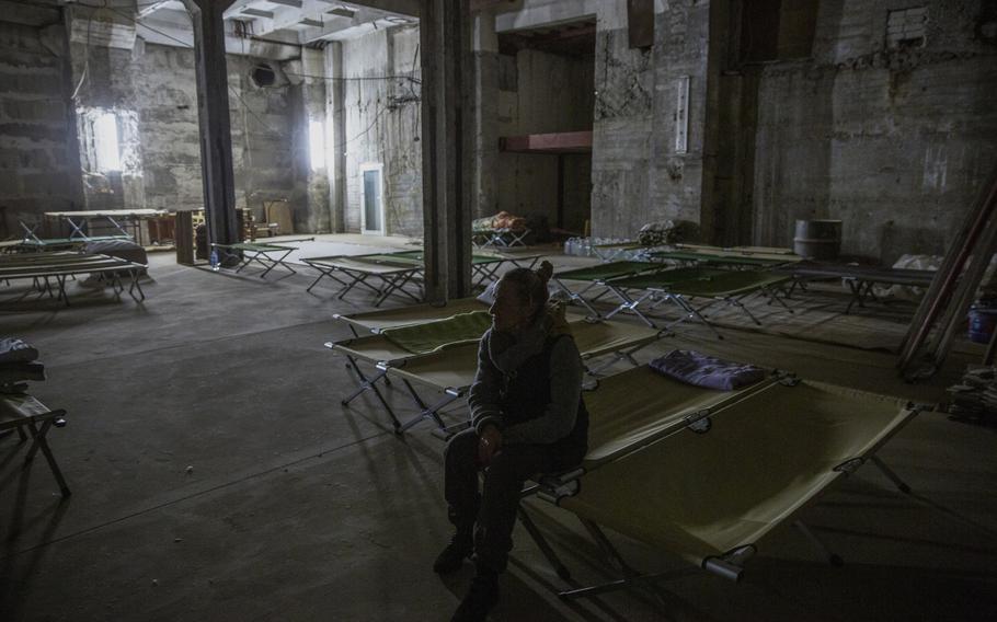 Nadia Melmuchuk sits on a cot during a tour of an underground shelter on Oct. 24 after her arrival in Zaporizhzhia with her husband and children from Russian-occupied Kherson.