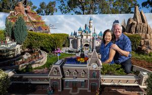 Architects David and Frances Sheegog pose with their mini Disneyland in their Anaheim Hills backyard, Jan. 11 in Anaheim, Calif.