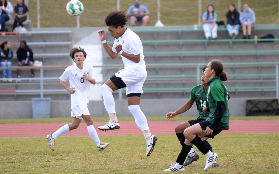 Kadena's Jellani McGhee heads the ball in front of Kubasaki's Jyumia Darsan and Gio Armour during Wednesday's DODEA-Okinawa boys soccer match. The Panthers blanked the Dragons 5-0.