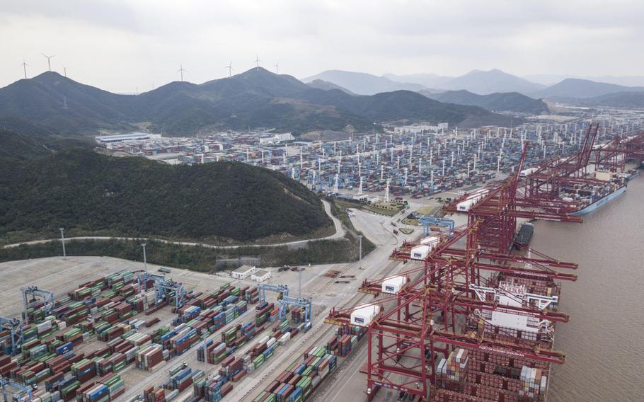 Containers sit stacked next to gantry cranes in this aerial photograph taken above the Port of Ningbo-Zhoushan in Ningbo, China, on Oct. 31, 2018.