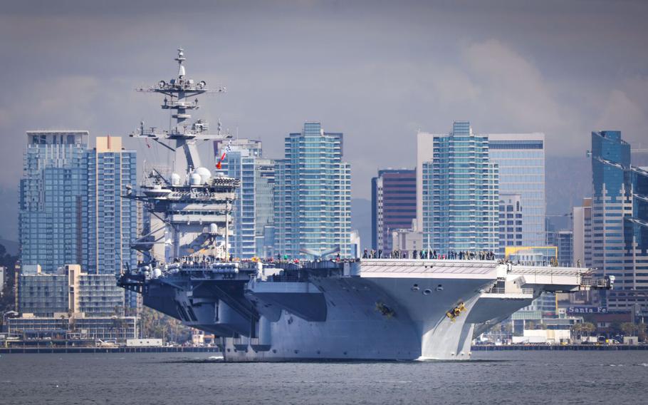 The aircraft carrier USS Theodore Roosevelt, flagship of Carrier Strike Group 9, travels through San Diego Bay as seen from Shelter Island after leaving Naval Air Station North Island, starting a scheduled deployment to the U.S. Indo-Pacific Command region, January 17, 2020, in San Diego.