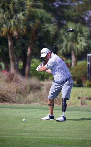 A man swings a golf club 