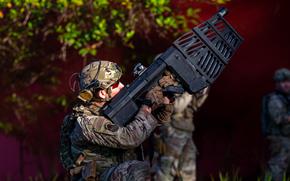 An Air Force security forces member aims a DroneDefender at a small drone during an exercise at East Range Training Area, Hawaii, Feb. 11, 2025. The Defense Department's new Task Force 401 aims to speed up the provision of tools for personnel to deal with small drones.