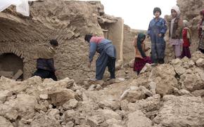 Afghan villagers remove bricks after their home was damaged by Monday's earthquake in the remote western province of Badghis, Afghanistan, Tuesday, Jan. 18, 2022.  
