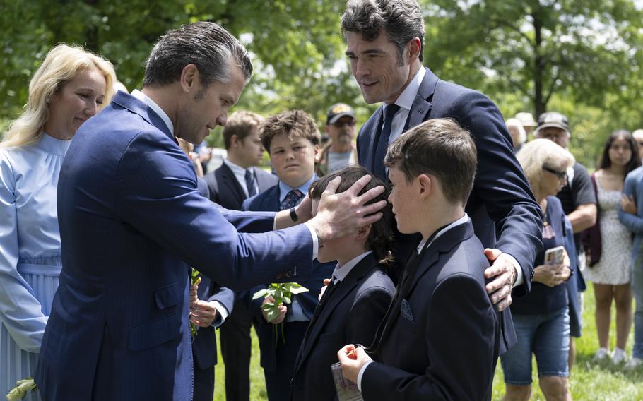 A man places his hands on a child’s head 