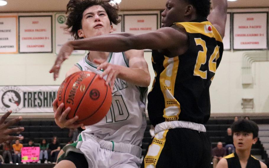 Kubasaki's Troy Harris drives for a shot against Kadena's Javontay Vickers during Thursday's Okinawa boys basketball game. The Panthers won 61-44.