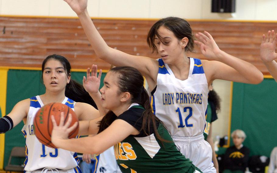 Robert D. Edgren's Samara Whitmore looks to pass against Yokota's Madison Van Gorder during Saturday's DODEA-Japan basketball game. The Panthers won 30-13.