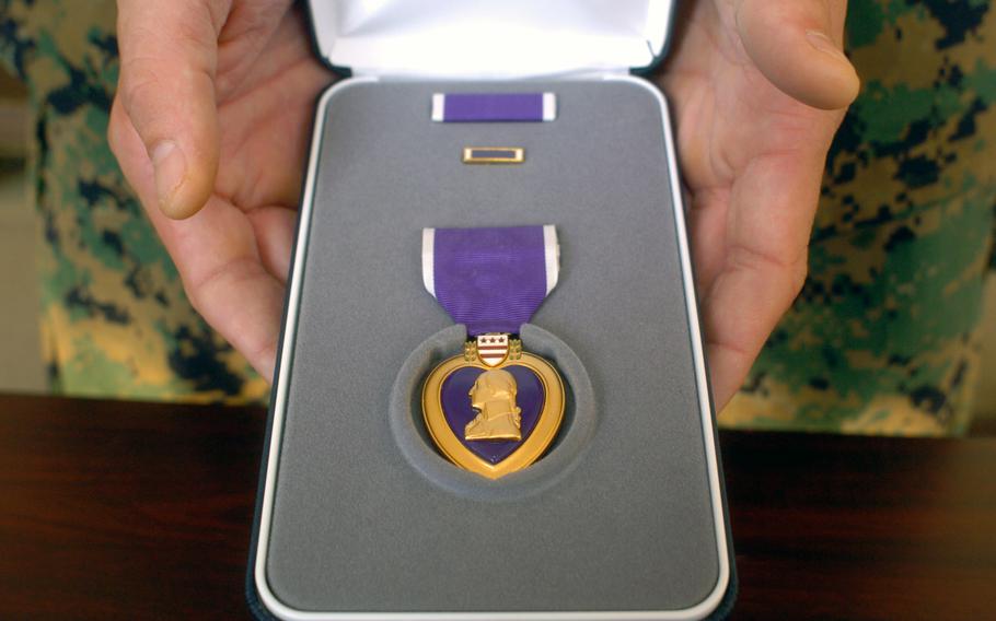 A Purple Heart is displayed.  A medal was recently given to the family of a recipient, nearly eight decades after his death. 
