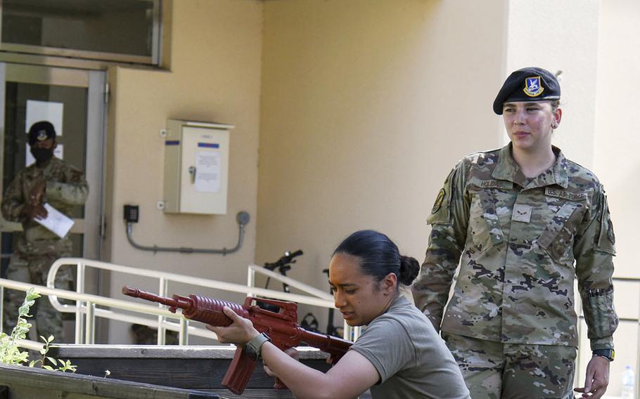 Airman 1st Class Taylor Arias aims a rubber rifle after being pepper-sprayed during training at Yokota Air Base, Japan, July 21, 2021.