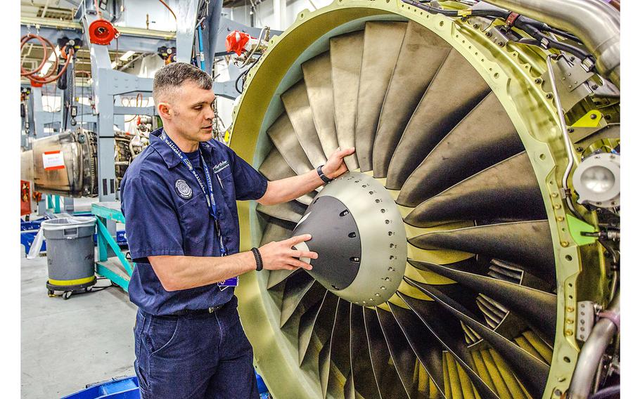Air Force Reserve aircraft mechanic Senior Master Sgt. Marty Hitt double checks a Boeing 737 aircraft engine to ensure it’s been repaired properly, at his civilian job with Alaska Airlines on April 24, 2014.
