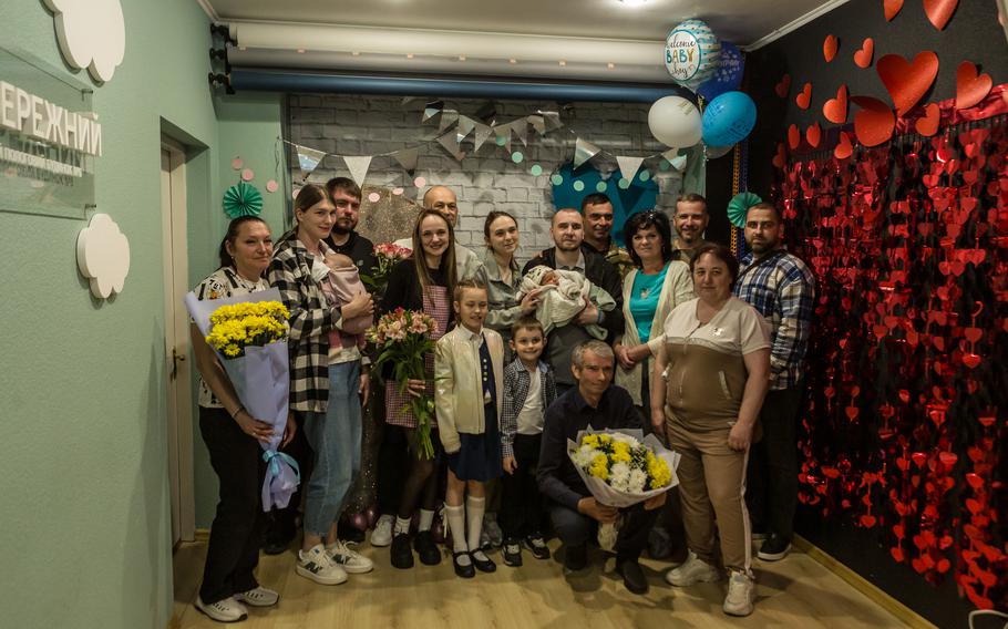 The Sorokas pose for a photo with friends and family three days after Sviatoslav was born.