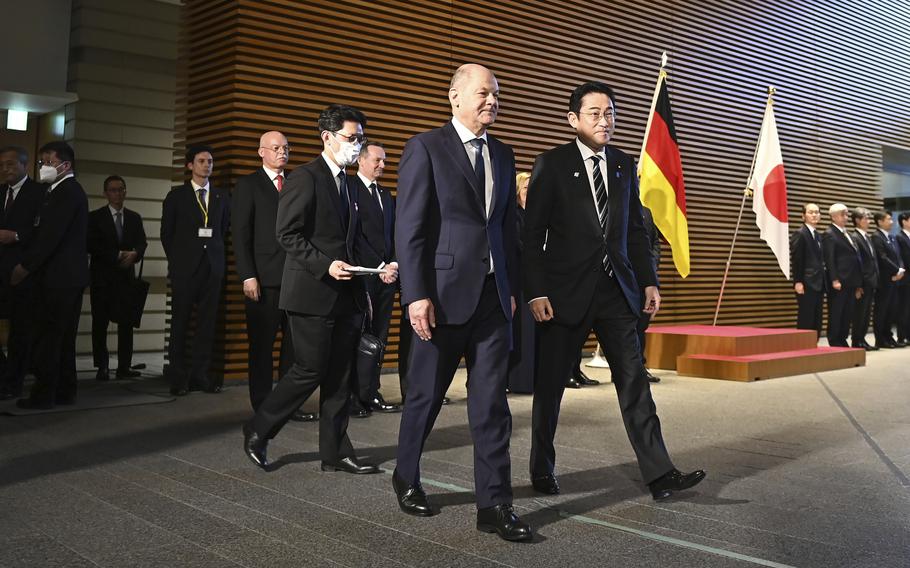 German Chancellor Olaf Scholz, front left, and Japan’s Prime Minister Fumio Kishida attend an honor guard welcoming ceremony  at the prime minister’s official residence in Tokyo Saturday, March 18, 2023. 