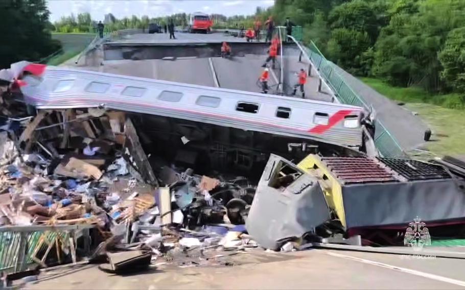 Emergency employees work at a collapsed bridge.