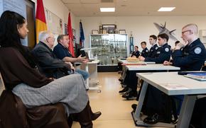 Retired Air Force Tech. Sgt. Dennis Walton, commander of the Veterans of Foreign Wars Post 10614, third from left, speaks with students at Kaiserslautern High School, Nov. 21, 2022. The Junior Reserve Officers Training Corps cadets donated $2,640 each to the local VFW and Fisher House branches. 