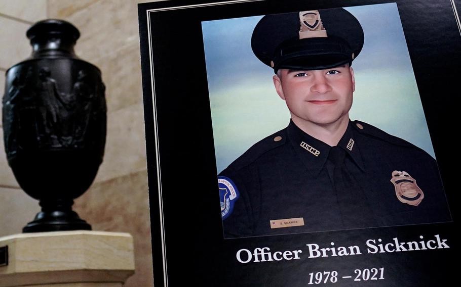 A sign just outside the Rotunda memorializes U.S. Capitol Police Officer Brian D. Sicknick, 42. Officer Sicknick was responding to the riot at the U.S. Capitol on Wednesday, Jan. 6, 2021, when he was fatally injured while physically engaging with the mob. Members of Congress will pay tribute to the officer on Wednesday morning before his burial at Arlington National Cemetery.