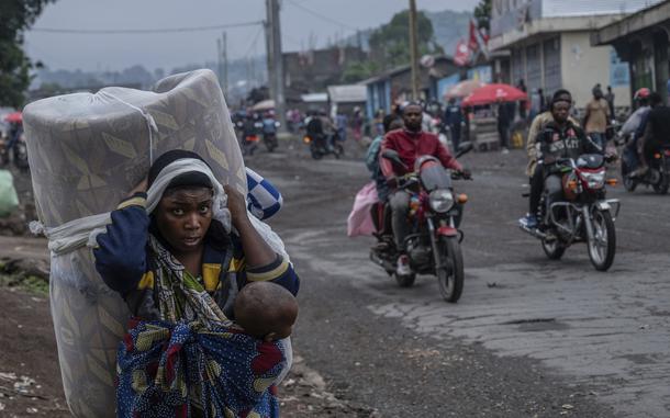 FILE - People displaced by the fighting with M23 rebels make their way to the center of Goma, Democratic Republic of the Congo, Sunday, Jan. 26, 2025. (AP Photo/Moses Sawasawa, File)