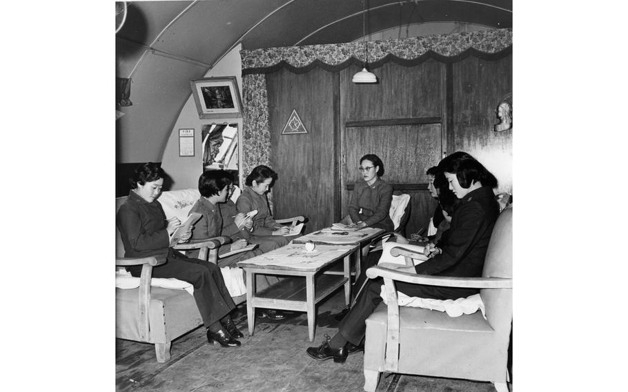 A number of Republic of Korea Women's Army Corps recruits sit and take notes in a cozy decorated room at the WAC Training Center in Seoul. 