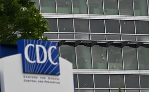 The sign ourside the CDC building, with the damaged windows in the background.