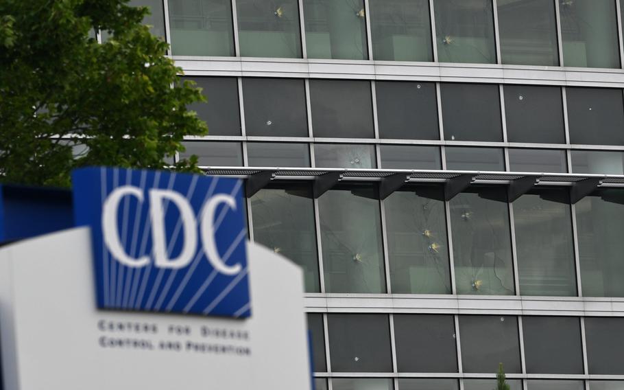 The sign ourside the CDC building, with the damaged windows in the background.