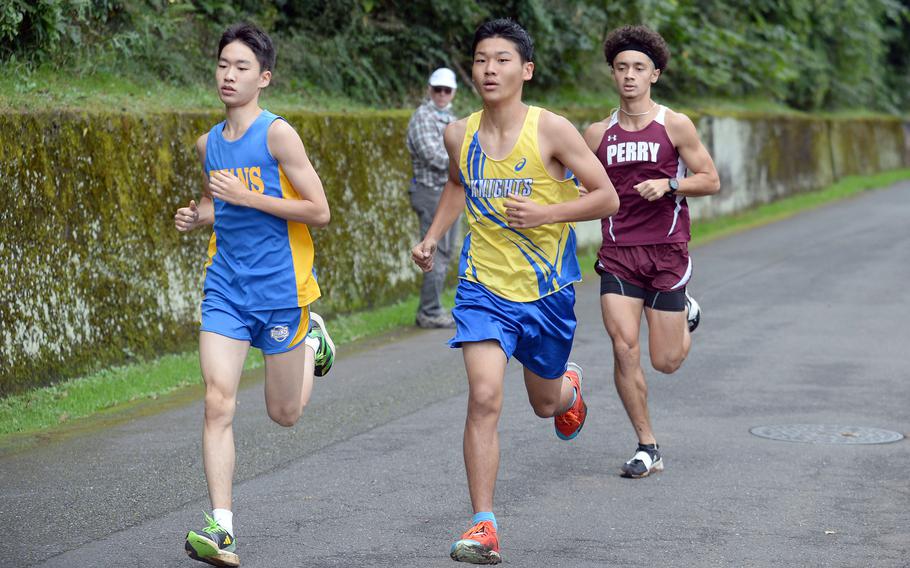 Matthew C. Perry junior Tyler Gaines keeps pace with overall race winner Jong in Lee of St. Mary's and Simon Nakamura of Christian Academy Japan, who finished third.