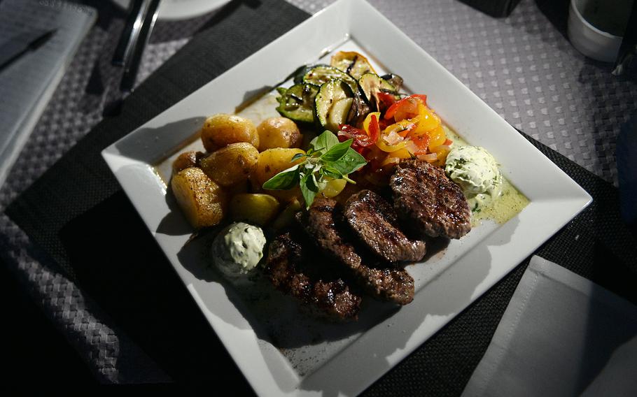 Slices of venison served at Markers Kleines Restaurant in Weilerbach, Germany, on Aug. 11, 2023. The dish included potatoes, zucchini, bell peppers and butter filled with spices.