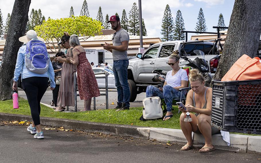 Residents gather at Napili Plaza in Lahaina, Hawaii, to connect to Starlink satellites to contact their loved ones on Friday, Aug. 11, 2023.