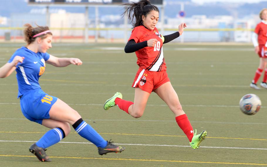 Yokota's Lucy Wellons sends the ball past Nile C. Kinnick's Mikaila Joi Miranda during Friday's DODEA-Japan soccer match. The teams played to a 1-1 draw.
