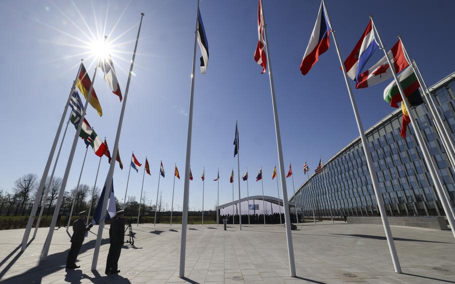 A series of flags in front of NATO HQ.