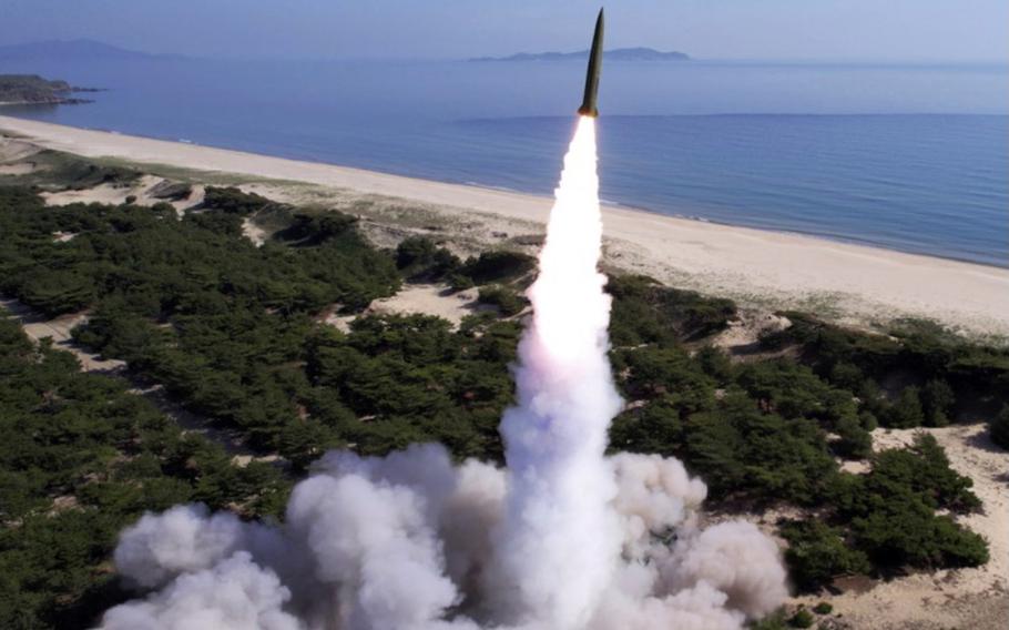 A short-range ballistic missile launches near water.