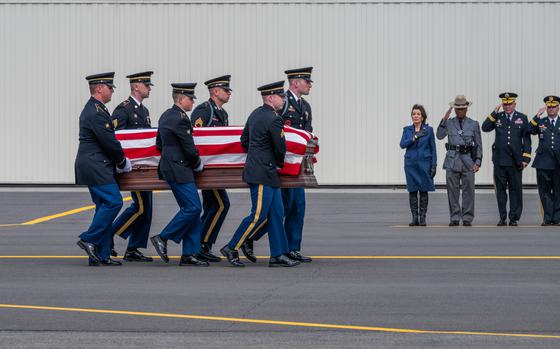 A New York Army National Guard Honor Guard team carries the remains of Chief Warrant Officer John M. Grassia III from a New York Air National Guard LC-130 to a hearse past a line of dignitaries, including New York Governor Kathy Hochul, during plane side honors conducted at the Army Aviation Support Facility in Latham, New York on March 18, 2024. Grassia and Chief Warrant Officer 2 Casey Frankoski were killed in a March 8 helicopter crash in Texas. Photo by Darren McGee/ courtesy Gov. Kathy Hochul's Office.