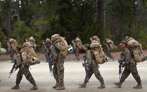 Marines, both male and female, participate in a 10 kilometer training march carrying 55 pound packs during Marine Combat Training (MCT) on Feb. 22, 2013, at Camp Lejeune, North Carolina. (Scott Olson/Getty Images/TNS)