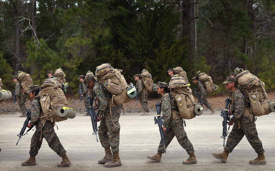 Marines participate in a 10 kilometer training march carrying 55 pound packs during Marine Combat Training (MCT) on Feb. 22, 2013, at Camp Lejeune, N.C.