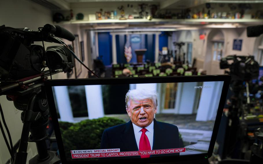 Then-President Donald Trump's recorded message to rioters is seen on a television screen in the White House briefing room as supporters are removed from the Capitol building, on Jan. 6, 2021, in Washington, DC.