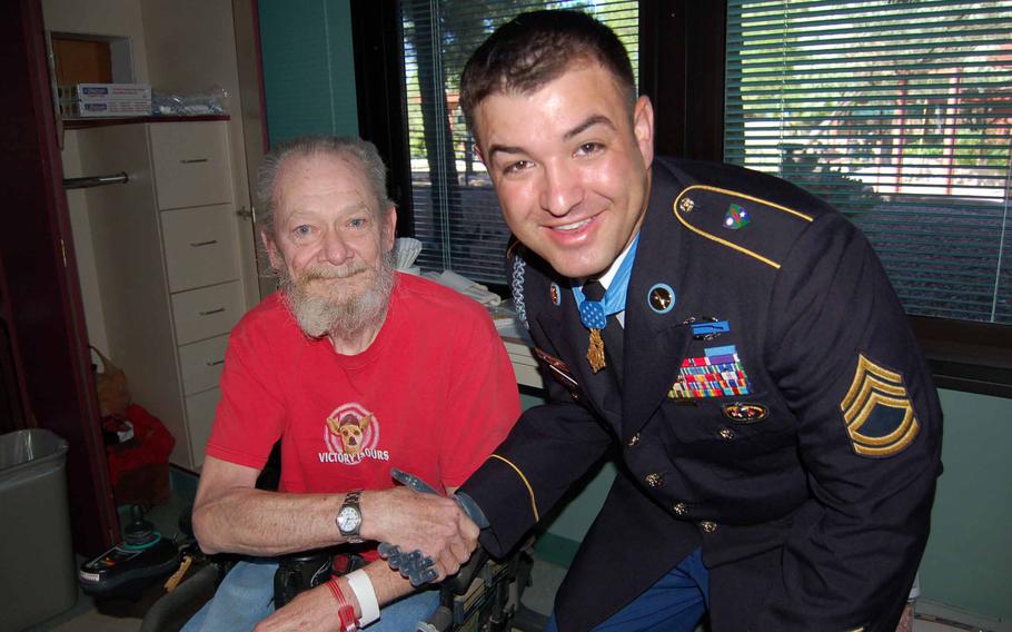 Medal of Honor recipient U.S. Army Sgt. 1st Class Leroy Petry (right) takes a moment to chat with George Johnson (left) while visiting the Raymond G. Murphy VA Medical Center in Albuquerque, NM in 2011.