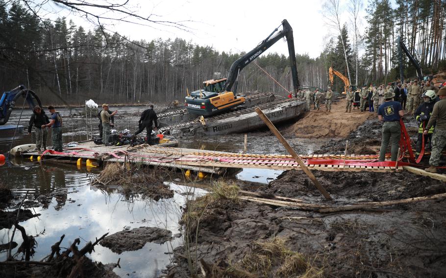 A digging vehicle sits in the background ad the platform is constructed.