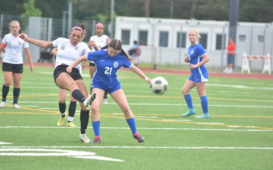 Stuttgart's Serenity Brown boots the ball away from Ramstein's Olivia Davis in the championship game of the DODEA European Division I girls soccer tournament Thursday, May 23, 2024, at Ramstein High School in Germany.