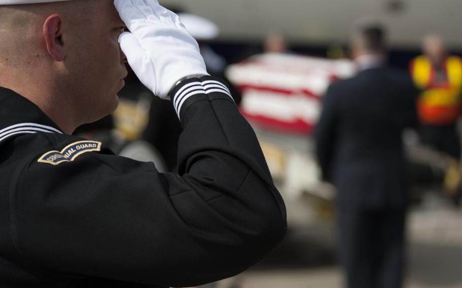 In this file photo, a member of the Navy’s ceremonial guard team salutes a casket at Washington Dulles International Airport. A Navy Reserve nurse became the 17th sailor to die of causes related to COVID-19. Lt. Ivey Quintana-Martinez died over the weekend in a Los Angeles hospital, where she had been since Nov. 10.