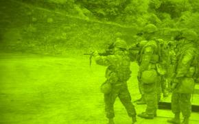 American and Korean soldiers practice shooting in this picture taken through a night vision lens.